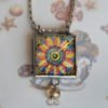 Danasimson.com Looking glass double-sided glass pendent pop-art flower. Beveled glass with a bead detail.