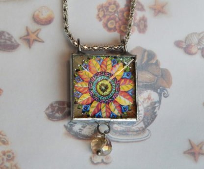 Danasimson.com Looking glass double-sided glass pendent pop-art flower. Beveled glass with a bead detail.
