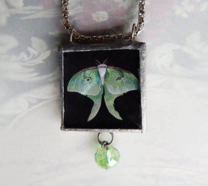 Danasimson.com Looking glass double-sided glass pendent Luna Moth. Beveled glass with a bead detail.