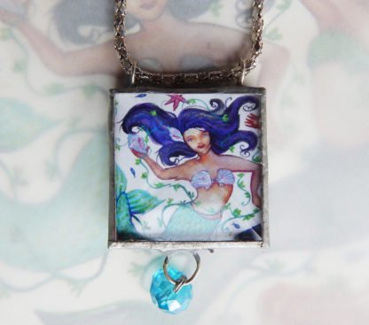 Danasimson.com Looking glass double-sided glass pendent mermaid. Beveled glass with a bead detail.