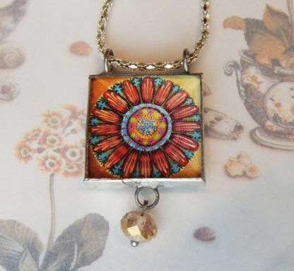 Danasimson.com front Looking glass double-sided glass pendent pop-art flower. Beveled glass with a bead detail.