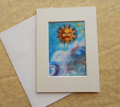 Danasimson.com Matted art card with envelope, "Rise and shine your beautiful unique light each day" quote, sun face image.