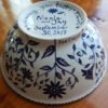 side view of outside of happy nest bowl with bride and groom's names and wedding date hand painted on bottom