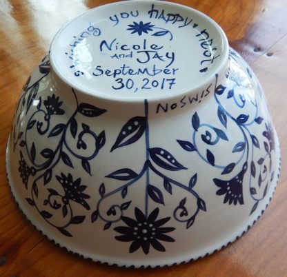 side view of outside of happy nest bowl with bride and groom's names and wedding date hand painted on bottom