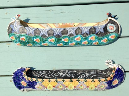 Danasimson.com two ceramic wall sculptures; canoes