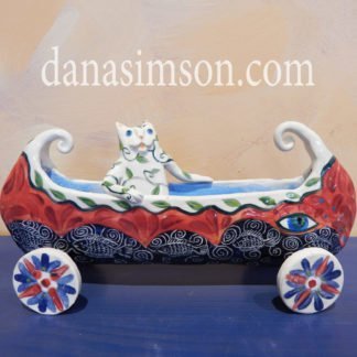 Danasimson.com Cat in canoe on wheels sculpture.