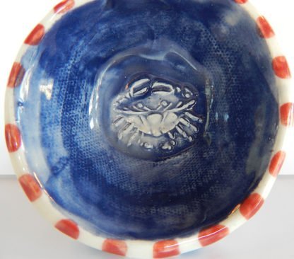 Danasimson.com Blue Crab coffee scoop inside scoop is a raised crab image. blue background red checks around the rim.