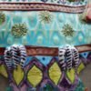Danasimson.com Owl wall sculpture detail of chest and claws. Relief ceramic in colorful glazes.