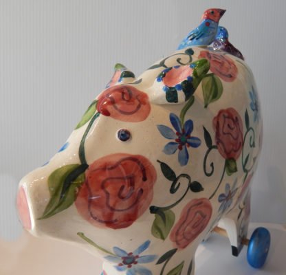 Danasimson.com Large pig sculpture with floral pattern on wheels.