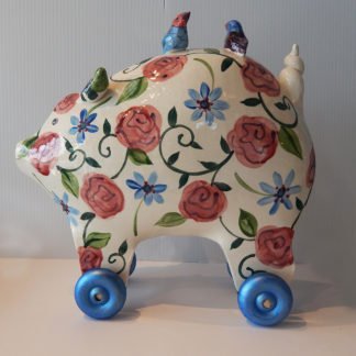 Danasimson.com Large pig sculpture with floral pattern on wheels.