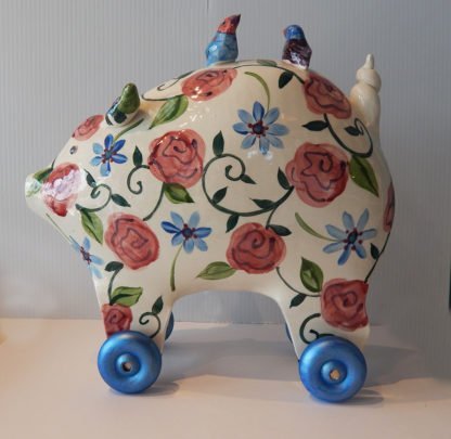Danasimson.com Large pig sculpture with floral pattern on wheels.
