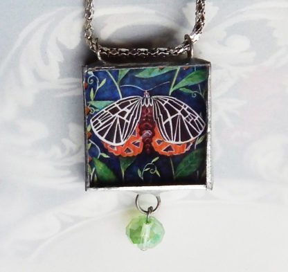 Danasimson.com Looking glass double-sided glass pendent tigarmoth. Beveled glass with a bead detail.