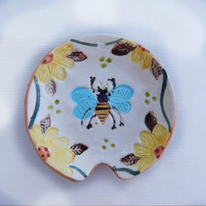 Danasimson.com Handmade ceramic honey bee spoon rest with raised detail.
