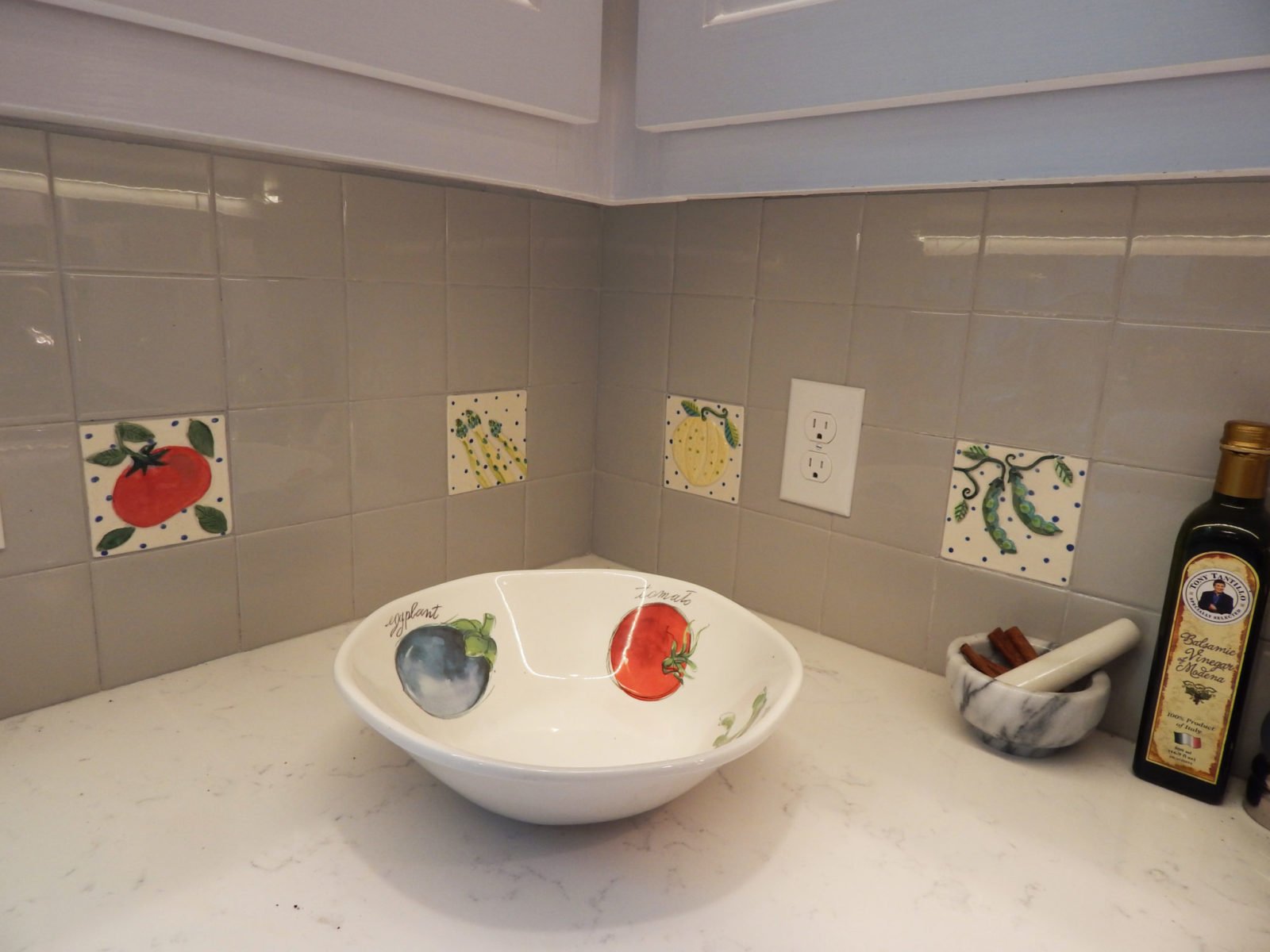 kitchen garden tiles in corner with a ceramic bowl.