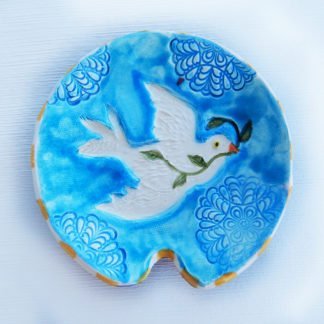 Danasimson.com Handmade ceramic spoon rest with raised image of peace dove.