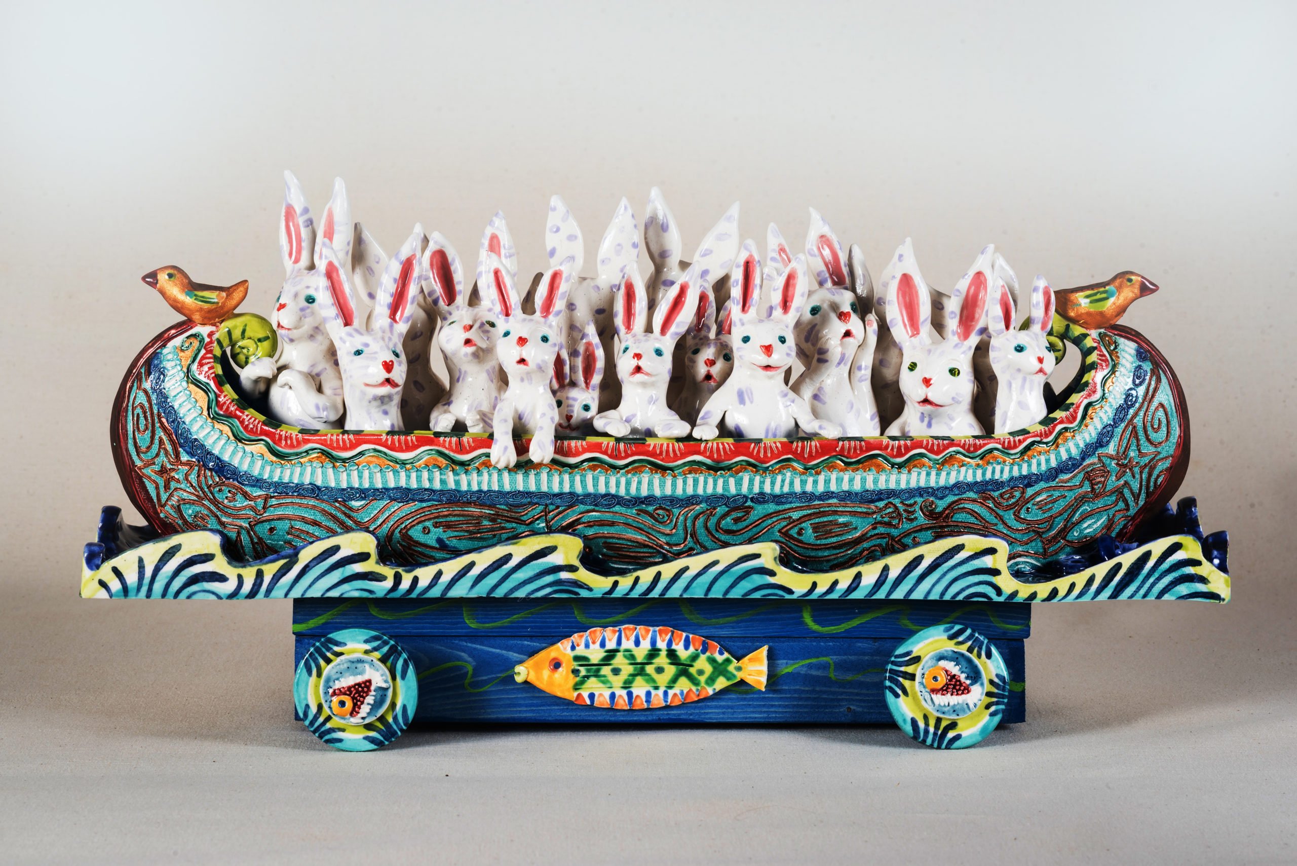 abbits in a folkart boat on wheels depict the issue of migration