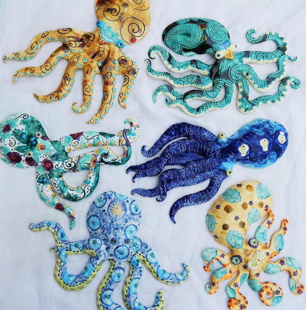 a variety of handmade ceramic octopus