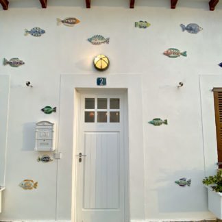 ceramic fish adorn the outside of a villa in Spain